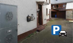 a door to a house with a car parked outside at Moselzauber Güls in Koblenz
