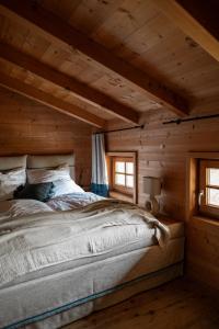 a bedroom with a bed in a log cabin at Oberortlhof - Juval in Kastelbell-Tschars