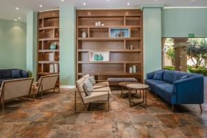 a lobby with a blue couch and chairs at Lindos Imperial Resort & Spa in Kiotari