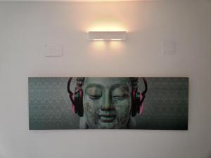 a picture of a woman wearing headphones on a wall at Apartment Tara in Sumartin