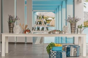 a table with fruits and vegetables on it next to a pool at Lindos Imperial Resort & Spa in Kiotari