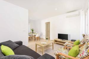 a living room with a couch and a table at Villa Tia Dora in Cala en Blanes
