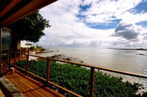 a view of the water from the deck of a house at Driftwood Beach Villa in Gordonʼs Bay