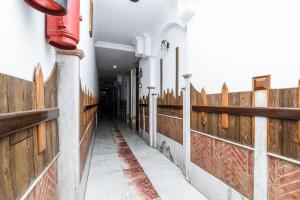 un corridoio di un edificio con recinzione in legno di Hotel Cottage Crown Plaza By My Rooms a Nuova Delhi