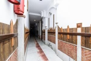 a hallway of a building with a wooden fence at Hotel Cottage Crown Plaza By My Rooms in New Delhi