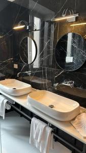 a bathroom with a toilet and a sink and mirrors at palazzo chinial in Torre del Greco