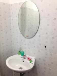 a bathroom with a sink and a mirror at SP House RoiEd in Roi Et