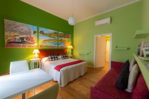 a green bedroom with a bed and a couch at QuodLibet in Rome