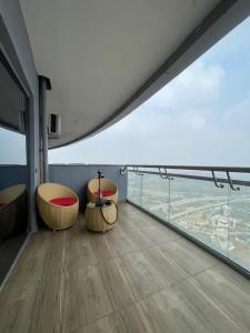 a room with two chairs and a view of the city at Skystay in Greater Noida