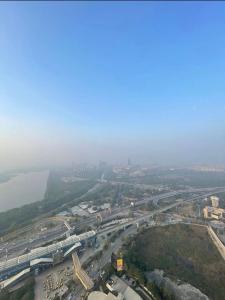 an aerial view of a city with a bridge and a freeway at Skystay in Greater Noida