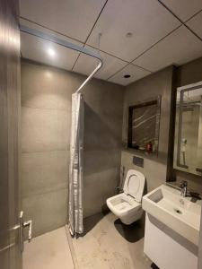 a bathroom with a toilet and a sink at Skystay in Greater Noida