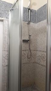 a shower with a glass door in a bathroom at Casaulmi in Otranto