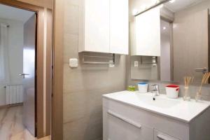 a bathroom with a sink and a mirror at Centric apartment Gran Via 5 in Hospitalet de Llobregat