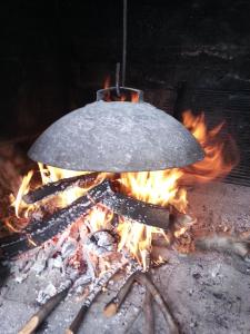 a wok on top of a camp fire at Apartment Tara in Sumartin