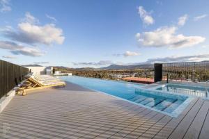 a swimming pool on the roof of a building at Blackdiamond 504 - Beautiful, modern apartment - 2BdR, 2BthR in Tuggeranong