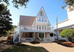 a large white house with a porch and a balcony at Spring Sale 4BR Home w heated pool 2 min to beach in Destin