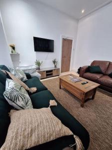 - un salon avec un canapé et une table basse dans l'établissement Anfield Abbey House, à Liverpool