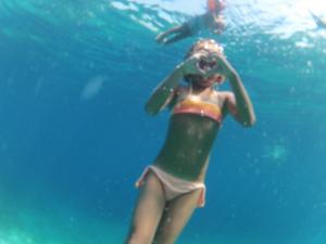 a woman is swimming in the water at Apartment Tara in Sumartin