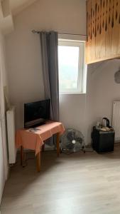 a room with a table and a window in a room at Auberge Alsacienne in Bussang