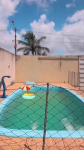 a playground with a trampoline in front of a building at Casa temporada marechal Deodoro in Marechal Deodoro