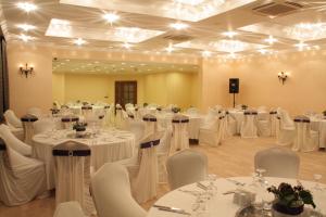 a room full of tables and chairs with white tablecloths at Tufad Prestige Boutique in Ankara