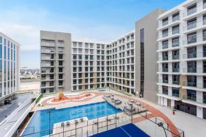 an overhead view of a large apartment building with a pool at WeHost - Urban Oasis Modern Studio Retreat with City Views in Dubai