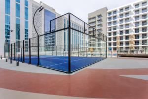 a tennis court in the middle of a building at WeHost - Urban Oasis Modern Studio Retreat with City Views in Dubai