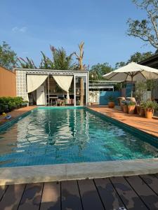 a swimming pool with blue water in a house at Lọ Lem home stay in Vĩnh Long