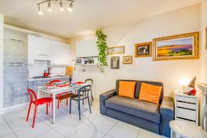 a kitchen and a living room with a table and a couch at Appartamento Le Mimose In Lucca - Happy Rentals in Lucca +16 photos
