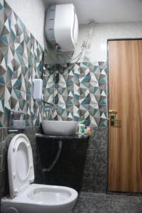 a bathroom with a toilet and a sink at Click Hotel Narayana in Ayodhya