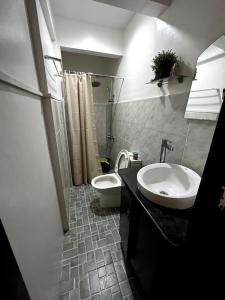 a bathroom with a sink and a toilet at Lovely 3-Bed House in Talisay Cebu Philippines in Talisay