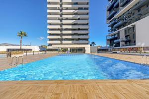 a swimming pool in front of a building at Alexia 2 Calpe in Calpe