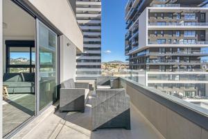 a balcony with chairs and a view of a building at Alexia 2 Calpe in Calpe