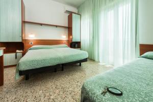 Posteľ alebo postele v izbe v ubytovaní Hotel Poseidon e Nettuno