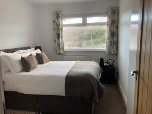 a bedroom with a large bed with a window at Glendale View in Glendale