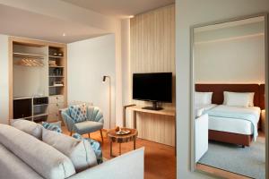 a hotel room with a bed and a living room at Dom Jose Beach Hotel (Plus) in Quarteira