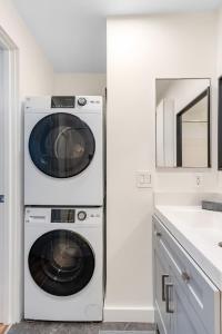 a washer and dryer in a kitchen next to a sink at Seattle's Gem: Elegant 1BR in Belltown in Seattle