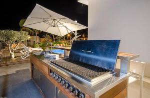 a laptop sitting on a table next to a pool at לוויט האוס in Poriyya Illit