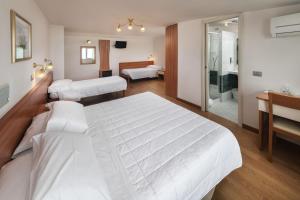 Posteľ alebo postele v izbe v ubytovaní Hotel Poseidon e Nettuno