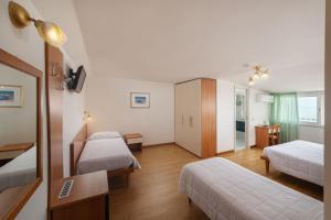 Posteľ alebo postele v izbe v ubytovaní Hotel Poseidon e Nettuno