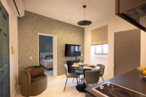 a kitchen and a living room with a table and chairs at Marina View 34 in Birgu