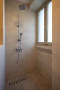 a shower stall in a bathroom with a window at Marina View 34 in Birgu