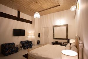 a bedroom with a bed and a mirror and a tv at Ekaa House in Manāli