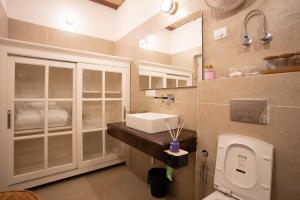 a bathroom with a sink and a toilet at Ekaa House in Manāli +17 photos