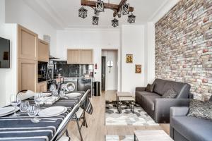 a kitchen and living room with a table and a couch at 138 Suite Wizman - Superbe Appartement à Paris in Paris