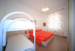 a bedroom with a bunk bed with a red bedspread at Hanbury 10 in Alassio