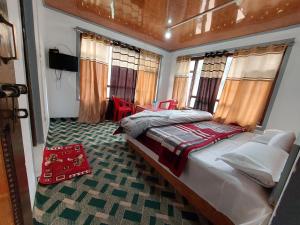 a bedroom with a bed in a room with windows at Forest inn pahalgam in Anantnāg