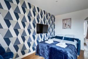 a bedroom with a blue and white patterned wall at 869-Suite Bleuet - Superb Apartment in Montreuil