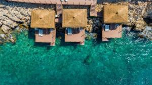 an aerial view of a group of houses on the water at Lures Hotel in Kalkan
