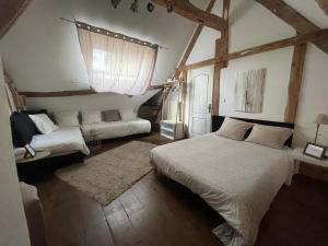 a bedroom with a bed and a couch in it at MAISON L in Tour-en-Sologne